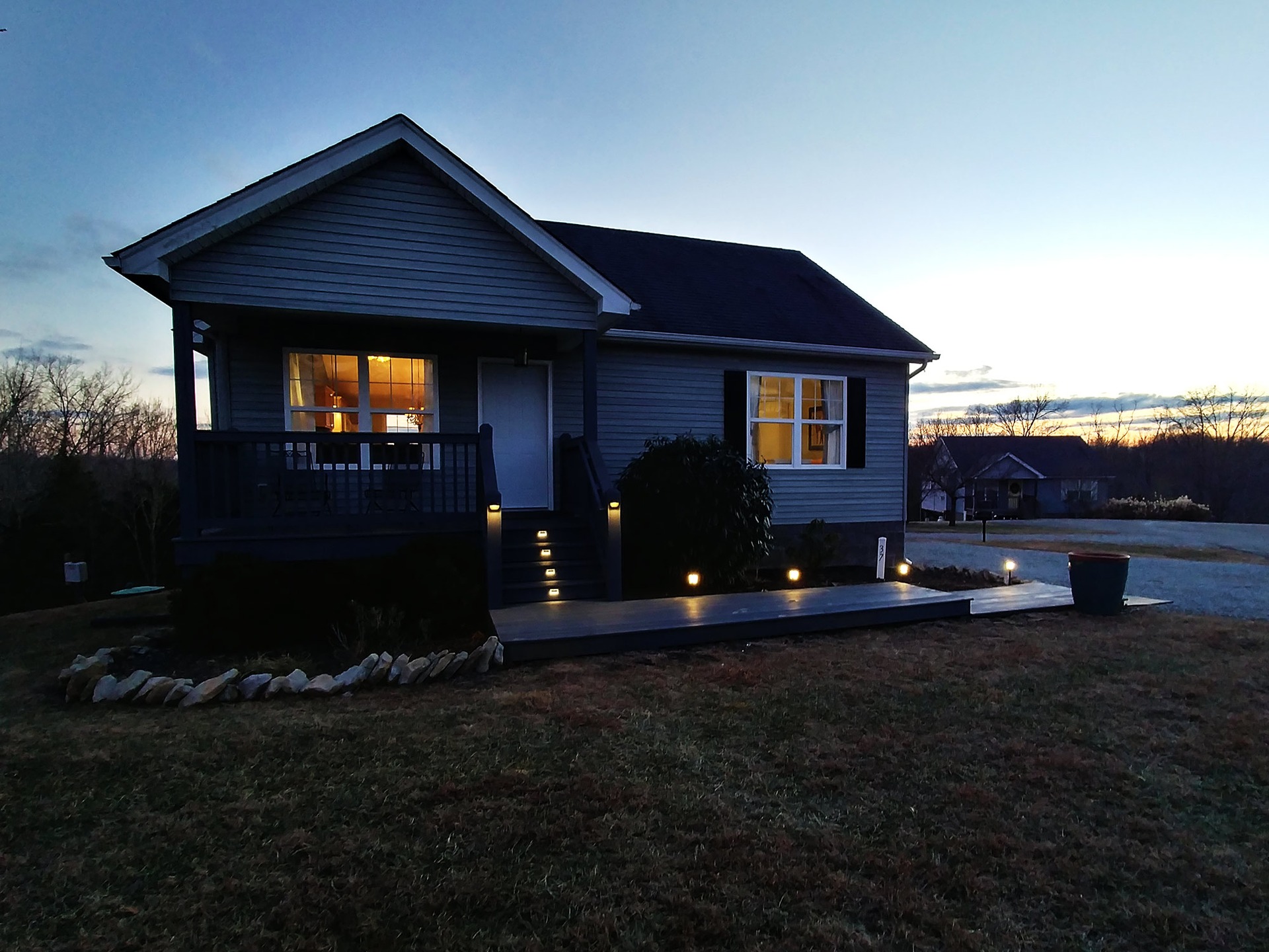 Cottage 37 welcoming exterior lights at dusk